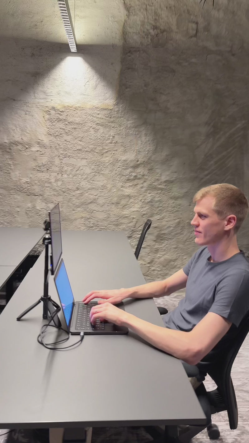Monitor with stand on coworking desk setup